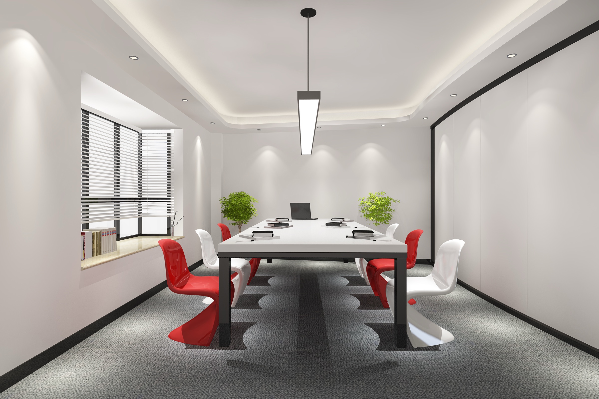 A crisp meeting room with a white conference table, sculptural red and white chairs and a bright bay window